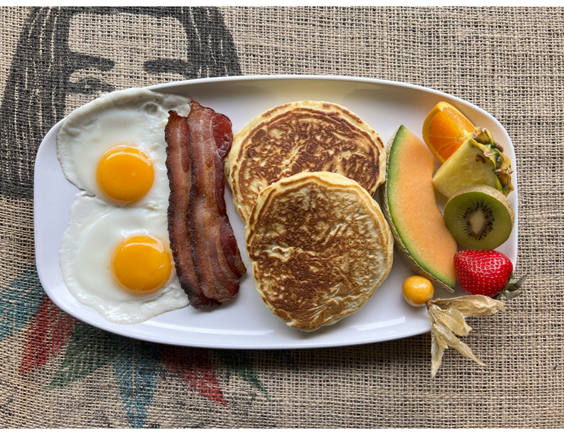 Drop 3 - 2 pancakes, 2 eggs any style, choice of protein, served with fruit garnish & roast potatoes